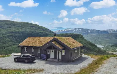 a small house with a car parked in front of it at Awesome Home In Norheimsund With Wifi in Norheimsund