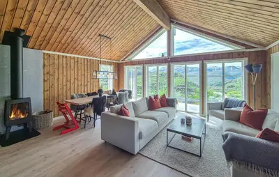 a living room with a couch and a fireplace at Awesome Home In Norheimsund With Wifi in Norheimsund