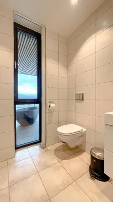 a bathroom with a toilet and a window at Magical view towards the fjords by the sea in Ålesund