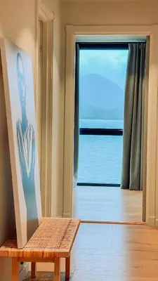 a room with a bench in front of a window at Magical view towards the fjords by the sea in Ålesund