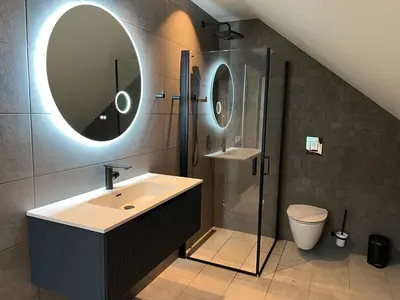 a bathroom with a sink and a shower and a mirror at Husslåttene apartments in Skei
