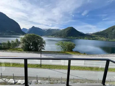 a view of a body of water with mountains at Husslåttene apartments in Skei