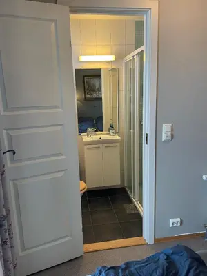 a bathroom with a sink and a mirror and a door at Fjellparken 351 in Beitostøl