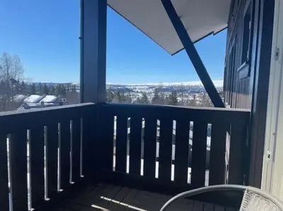 a balcony with a chair and a view of the city at Fjellparken 351 in Beitostøl