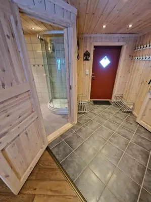 a large room with a door and a tiled floor at Hytte Gaustablikk in Gaustablikk