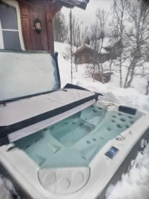 a hot tub in the snow in front of a house at Hytte Gaustablikk in Gaustablikk