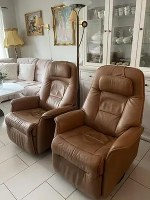 a living room with a couch and a chair at Flott leilighet in Bergen