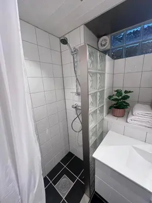 a bathroom with a shower and a sink at Koselig leilighet i Ålesund sentrum in Ålesund
