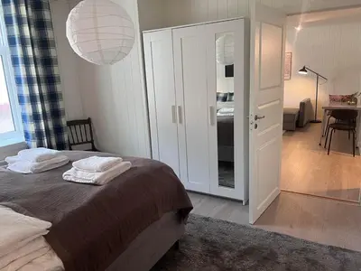 a bedroom with a bed with two towels on it at Koselig leilighet i Ålesund sentrum in Ålesund