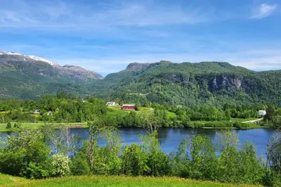 a view of a lake with mountains in the background at Shelby's Home in Heimstad