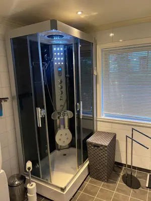 a shower stall in a bathroom with a window at Fjordhus in Austerheim