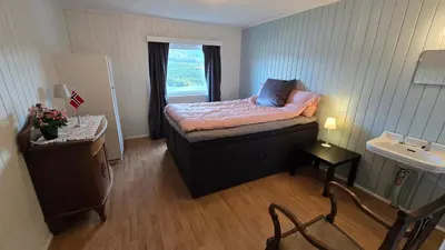 a small bedroom with a bed and a sink at Knobelauch Family Home, Valdres in Vøle