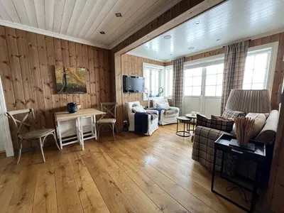 a living room with a couch and a table at Cozy Apartment With Stunning Mountain Views in Beitostøl