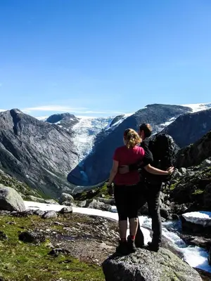 a man and woman standing on top of a mountain at Oldevatn Camping in Olden