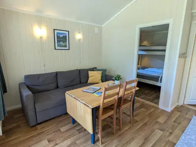 a living room with a couch and a table at Oldevatn Camping in Olden