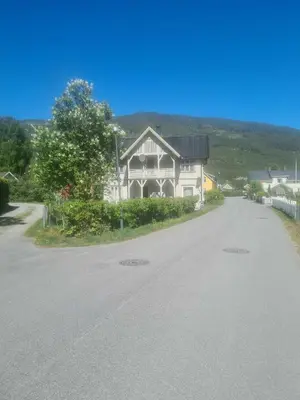 a large house on the side of a road at Koselig Sentrumsleilighet i 2 etg in Nes i Ådal