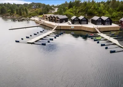 an aerial view of a marina with boats on the water at Eksklusiv hytte i skjærgården! in Austevoll