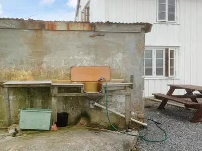 a wooden table with a pot on it next to a picnic table at 11 person holiday home in Bud-By Traum in Bud