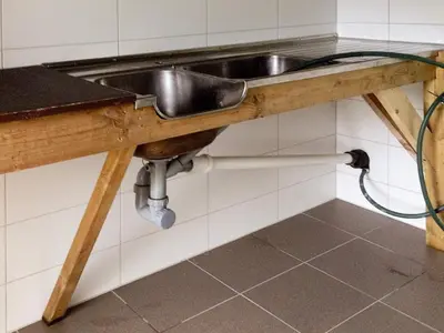 a kitchen sink with a hose under it at 11 person holiday home in Bud-By Traum in Bud