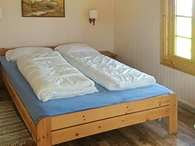 a bed with white sheets and a blue mattress at 11 person holiday home in Bud-By Traum in Bud