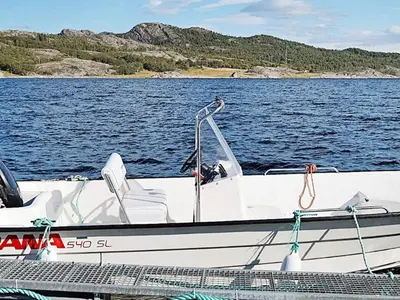a white boat sitting on a body of water at 15 person holiday home in Flatanger-By Traum in Straum