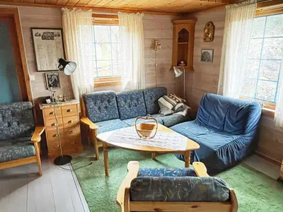 a living room with a blue couch and a table at 6 person holiday home in Åkra-By Traum in Kyrping