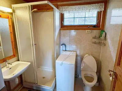 a small bathroom with a toilet and a sink at 6 person holiday home in Åkra-By Traum in Kyrping