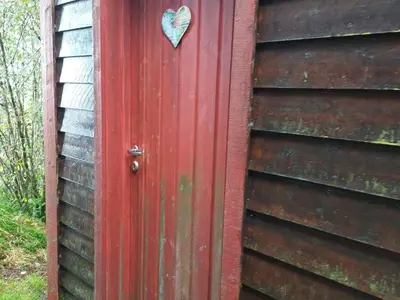 a red door with a heart on it at 7 person holiday home in Skjold-By Traum in Skjold