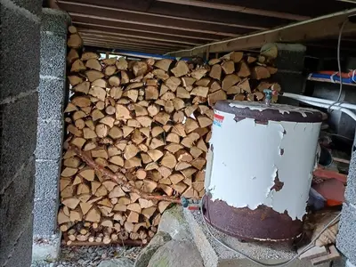 a pile of fire wood sitting next to a wall at 7 person holiday home in Skjold-By Traum in Skjold