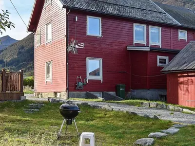 a bbq grill in front of a red house at 4 person holiday home in Måndalen-By Traum in Sæbø