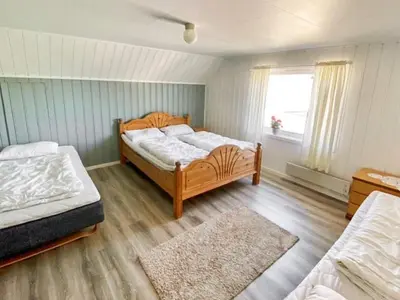 a bedroom with two beds and a window at 10 person holiday home in VEVANG-By Traum in Vevang