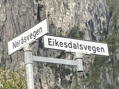 two white street signs on top of a pole at 4 person holiday home in Eresfjord-By Traum in Øverås