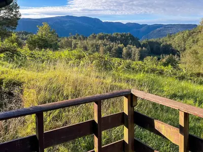 a wooden fence with a view of the mountains at 5 person holiday home in Brekke-By Traum in Dingja