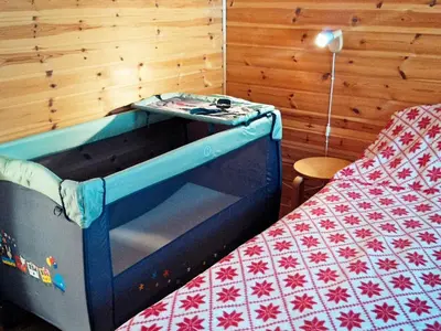 a bedroom with a bed and a toyoir with a bed sidx sidx sidx sidx at 8 person holiday home in Norheimsund-By Traum in Norheimsund