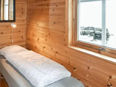 a bench in a room with a window at 7 person holiday home in Selje-By Traum in Selje
