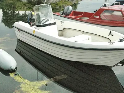 a white boat is sitting in the water at 6 person holiday home in Farstad-By Traum in Farstad