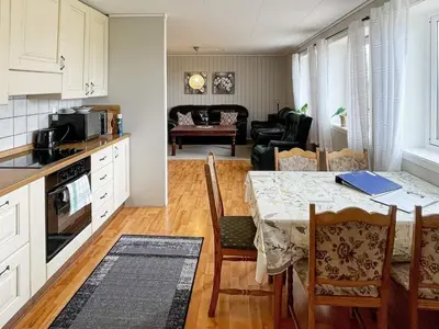 a kitchen and a living room with a table and a living room at 6 person holiday home in Farstad-By Traum in Farstad