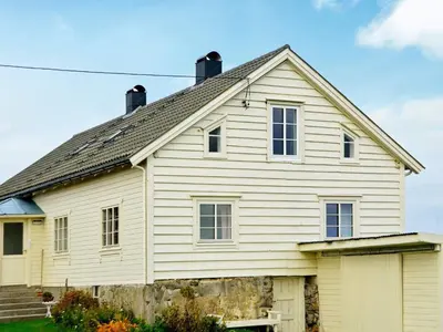 a white house with a gray roof at 11 person holiday home in Fjørtoft-By Traum in Fjørtoft