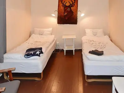 two beds in a room with white sheets at 11 person holiday home in Fjørtoft-By Traum in Fjørtoft