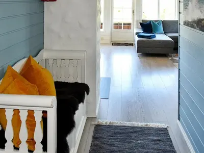 a living room with a couch and a chair at 9 person holiday home in Farstad-By Traum in Farstad