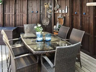 a glass table and chairs on a patio at 9 person holiday home in Farstad-By Traum in Farstad
