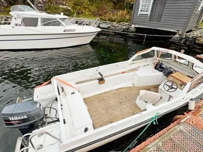 a white boat is docked in the water at 6 person holiday home in Svelgen-By Traum in Sørgulen