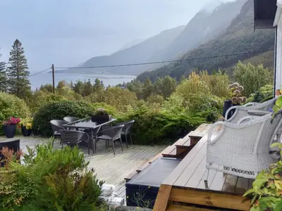 a patio with a table and chairs and a view of the mountains at 6 person holiday home in Åram-By Traum in Sandvik