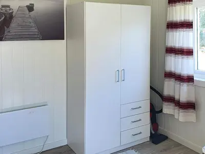 a white cabinet in a room with a window at 6 person holiday home in Storfosna-By Traum in Sletta