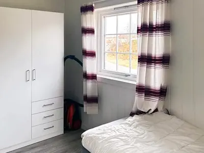 a bedroom with a bed and a window at 6 person holiday home in Storfosna-By Traum in Sletta