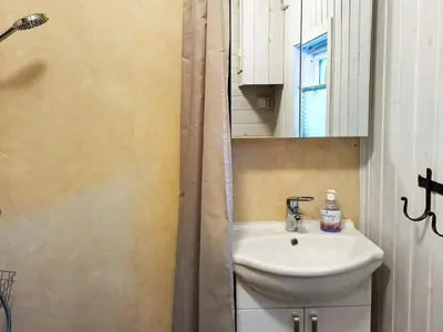 a bathroom with a sink and a mirror and a shower at 4 person holiday home in Øydegard-By Traum in Torvikbukt