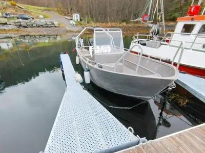 a boat is docked at a dock in the water at 4 person holiday home in Øydegard-By Traum in Torvikbukt