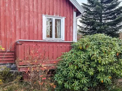 a red house with a window on the side of it at 8 person holiday home in isfjorden-By Traum in Torvik