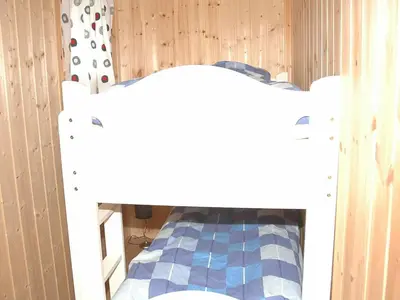 a bedroom with a bed with a white bed frame at 8 person holiday home in isfjorden-By Traum in Torvik
