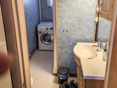 a bathroom with a sink and a washing machine at 8 person holiday home in isfjorden-By Traum in Torvik
